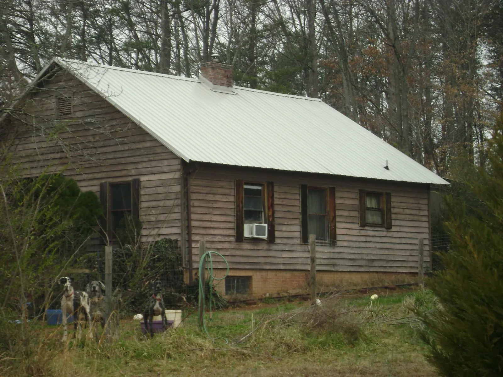 White metal roof on an old wood sided farmhouse, from a Metal Roof Installation job in Vincent